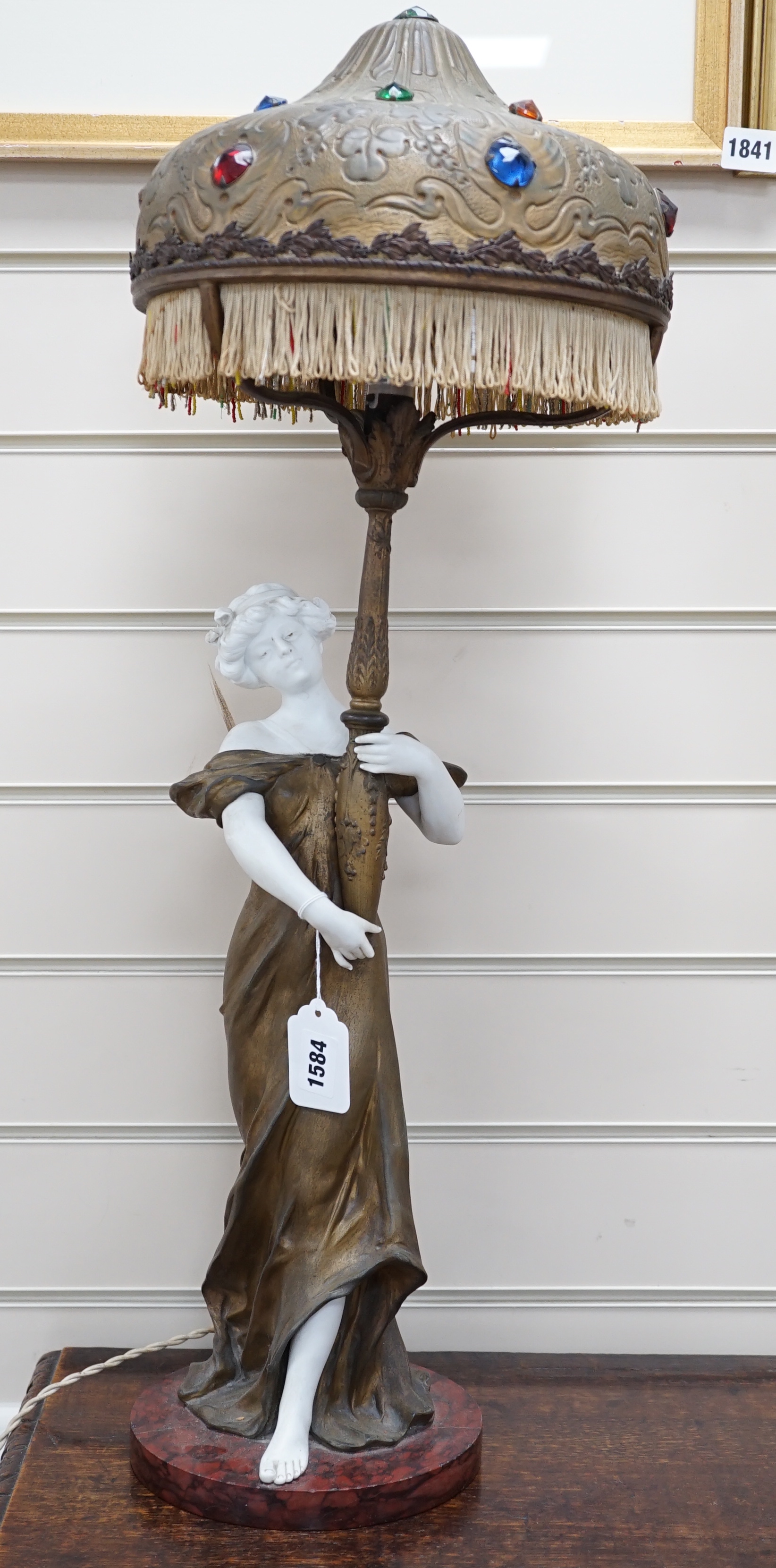 An Art Nouveau gilt-spelter and bisque figural table lamp, on rouge marble base, jewelled gilt-spelter shade, 73cm tall